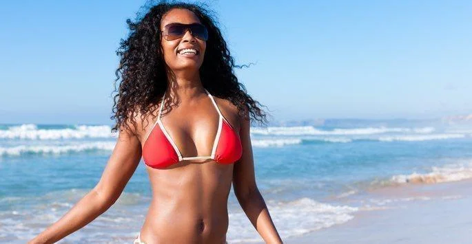 Woman in red bikini top at the beach