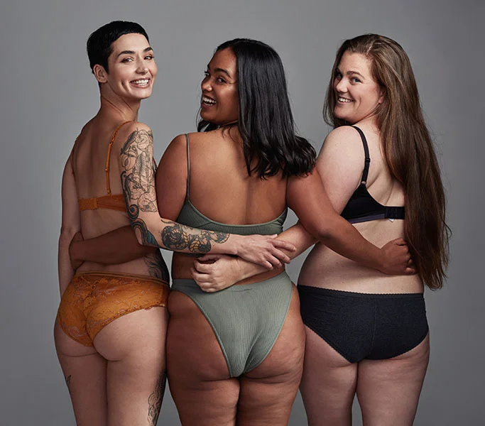 3 Women posing together in bikinis after liposuction procedure
